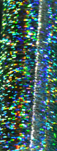 Super close-up of iridescent blue and green holoshimmer metallic thread