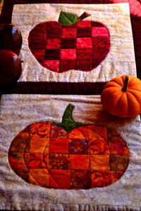 pumpkin and apple on a fall table runner - paperbacked fusible webbing used for sewing appliques on quilts