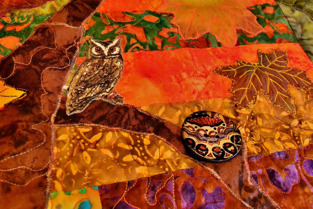 Owl and butterfly button on a zipper back background